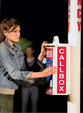 Image of woman pressing emergency callbox button.